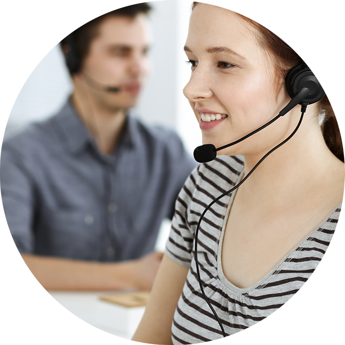 An image of a man and a woman wearing a headset working on a senior living live chat team